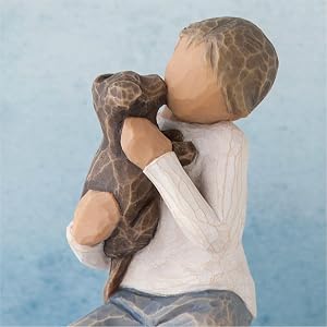 Close up detail of figure holding dog.