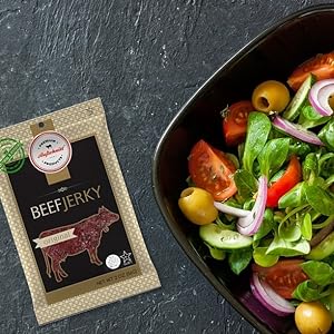kosher beef jerky sitting beside a vegetable salad