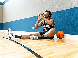 Basketball player rehydration with Re-Lyte Pre-Workout to support recovery, replenish electrolytes.