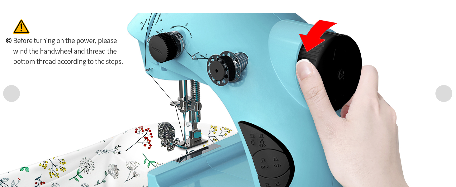 Sewing machine with light blue fabric and a person's hand holding scissors. Decorative stitching patterns visible on fabric.
