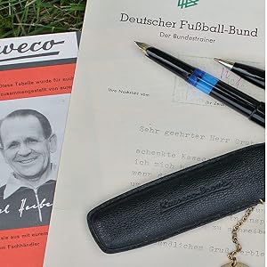 a pen, pen and a pen on a grass field.