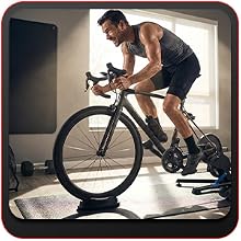 Athlete performing high-intensity intervals on a bike trainer with a bike front wheel riser block.