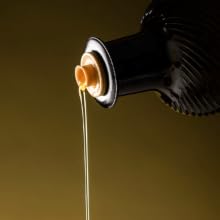 Olive oil pouring out of the bottle