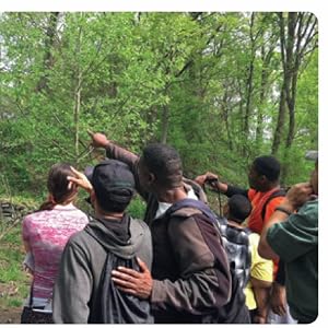 Audubon Discovery Center educator birders spot birds using tree clock face bird treetop trunk