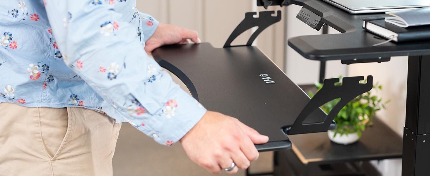 Man removing keyboard tray