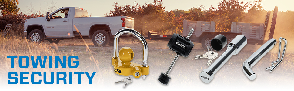 Pickup truck pulling a heavy duty flatbed trailer with REESE towing security products in foreground