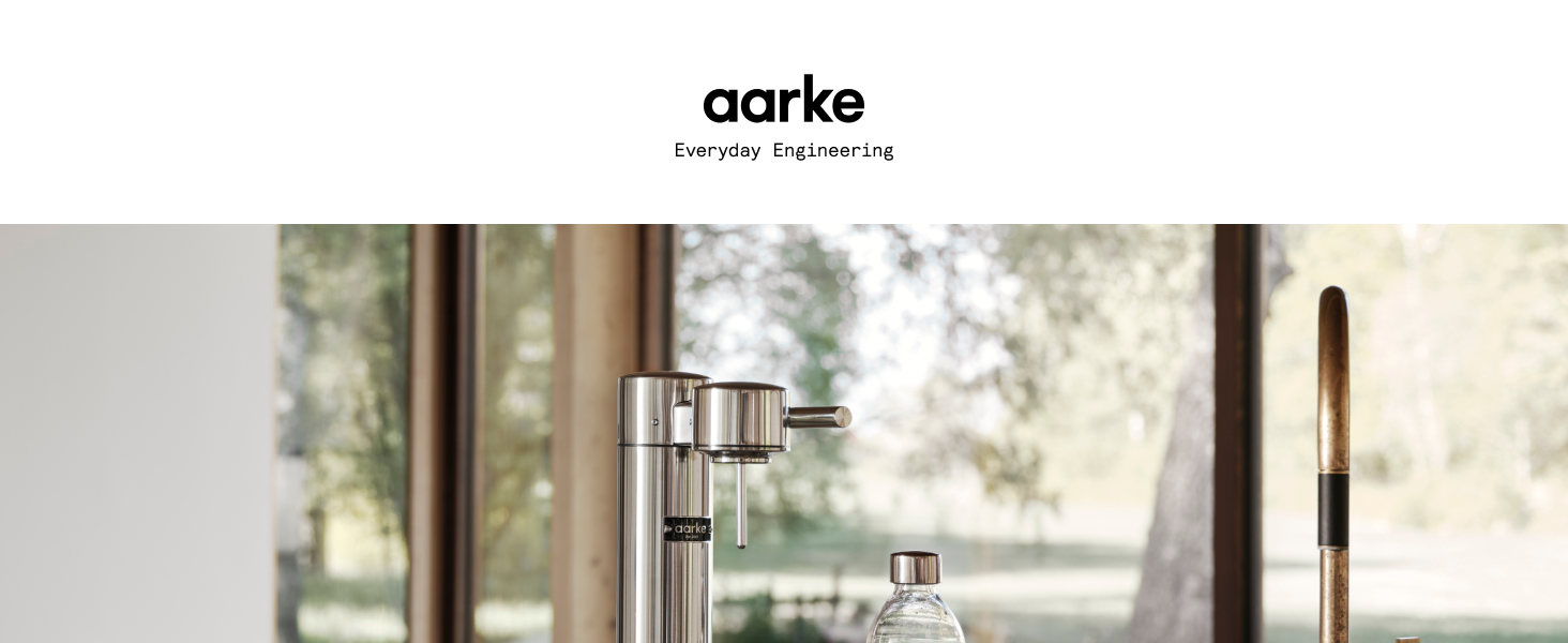 Aarke logo with image of stainless steel Carbonator 3 on counter with windows overlooking yard