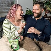 Couple sitting on couch eating Chocolove mint bites