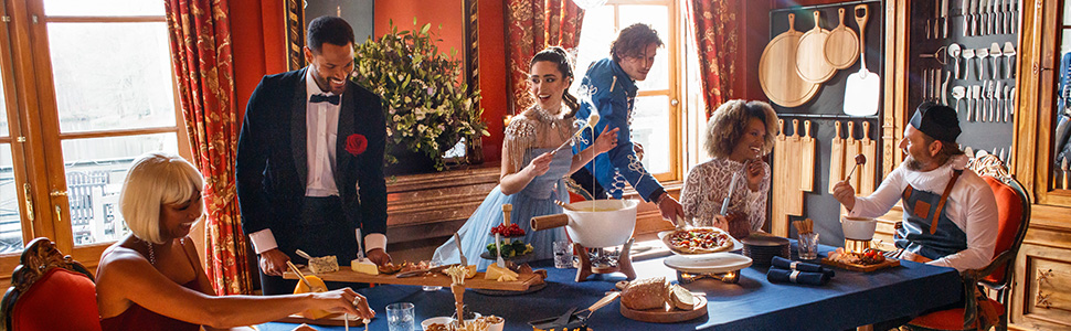 a group of people standing around a table with food.
