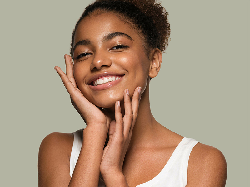 smiling woman touching face