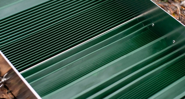 rubber riffle sluice box matting in sluice box place on ground next to river