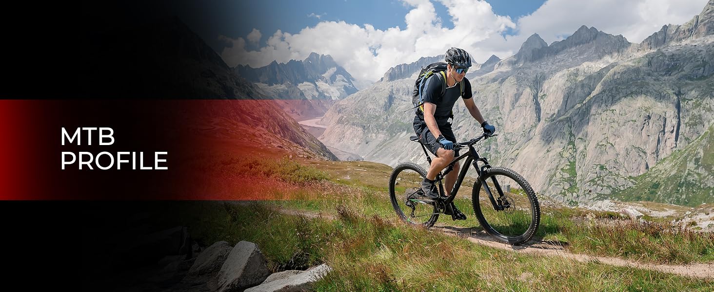 Mountain biker riding on a trail with snow-capped mountains in the background. Text overlay reads 'MTB PROFILE', suggesting a mountain biking product or feature.