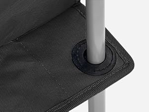 Close-up of a dark fabric surface with a circular hole, likely for a pole or stand to pass through.