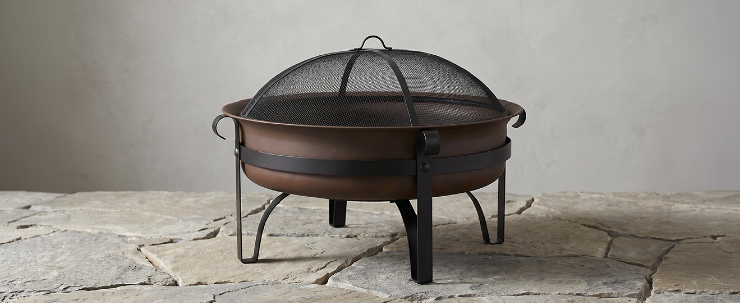 34-inch steel cauldron fire pit with mesh spark screen on stone floor with grey background