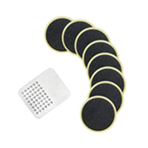 Multiple round black discs with yellow trim arranged in a scattered pattern, alongside white grid-patterned squares.