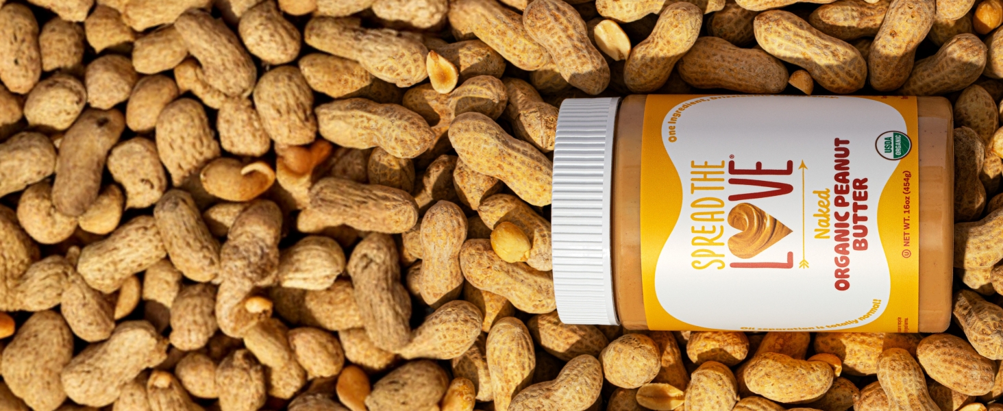 NAKED Organic Peanut Butter surrounded by peanuts