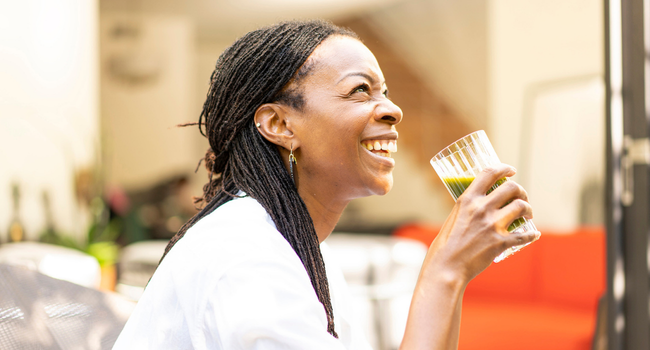 Person enjoying an Earthrise spirulina smoothie.