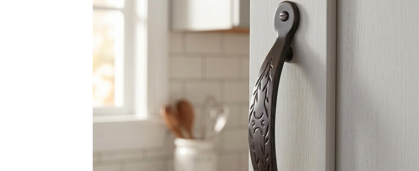 An oil rubbed bronze cabinet pull on a white cabinet lifestyle image