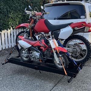 Youth Adult Dirt Bike Secured to Titan Ramps Dual Aluminum Carrier on SUV Hitch Driveway Parked