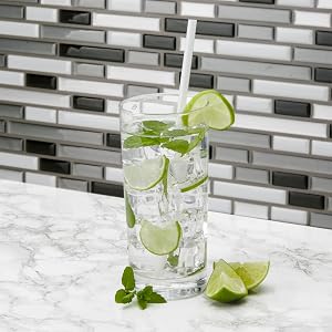 plant based straw in a drink with limes