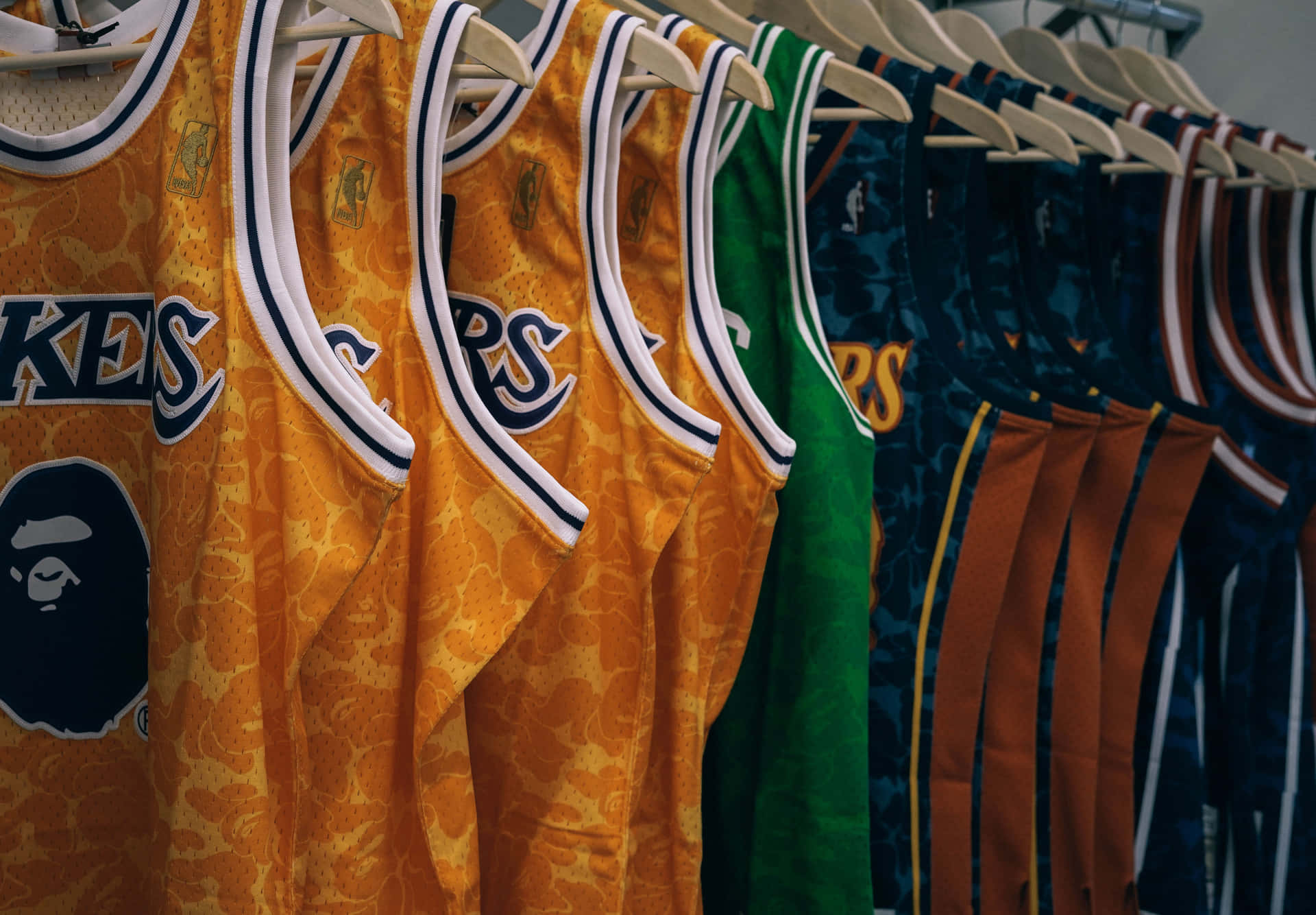 NBA jerseys hanging in a row
