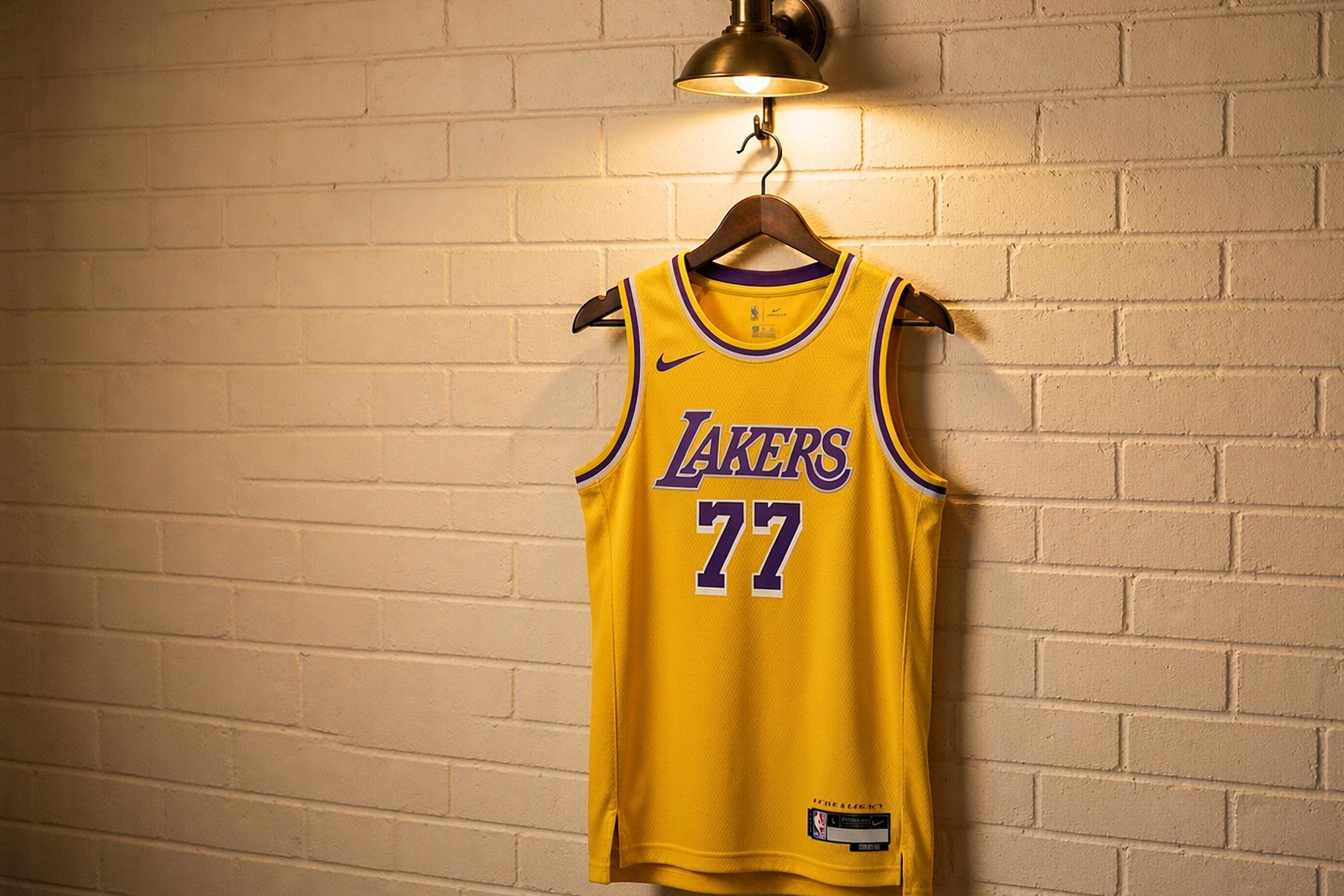 An NBA Icon Edition jersey hanging in a real locker room, with the team wordmark and number visible on the chest