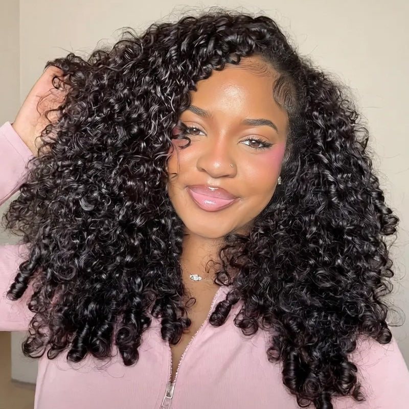 Woman With Burmese Curly Wig Wearing A Pink Top Against A Neutral Background