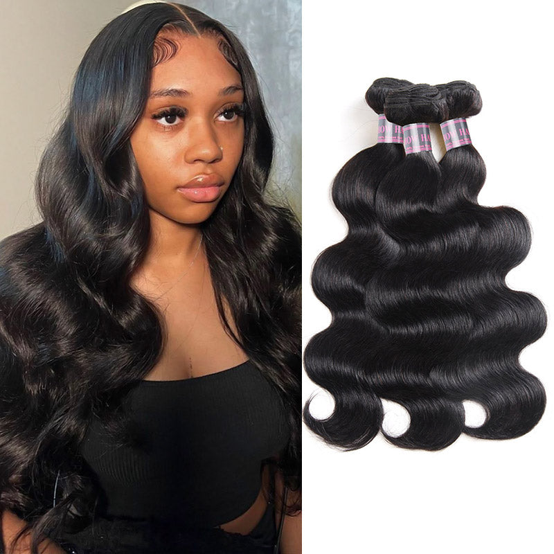 Woman with long, jet black, wavy human hair extensions in a black tank top next to three bundles of Ishow jet black, wavy Brazilian virgin human hair.