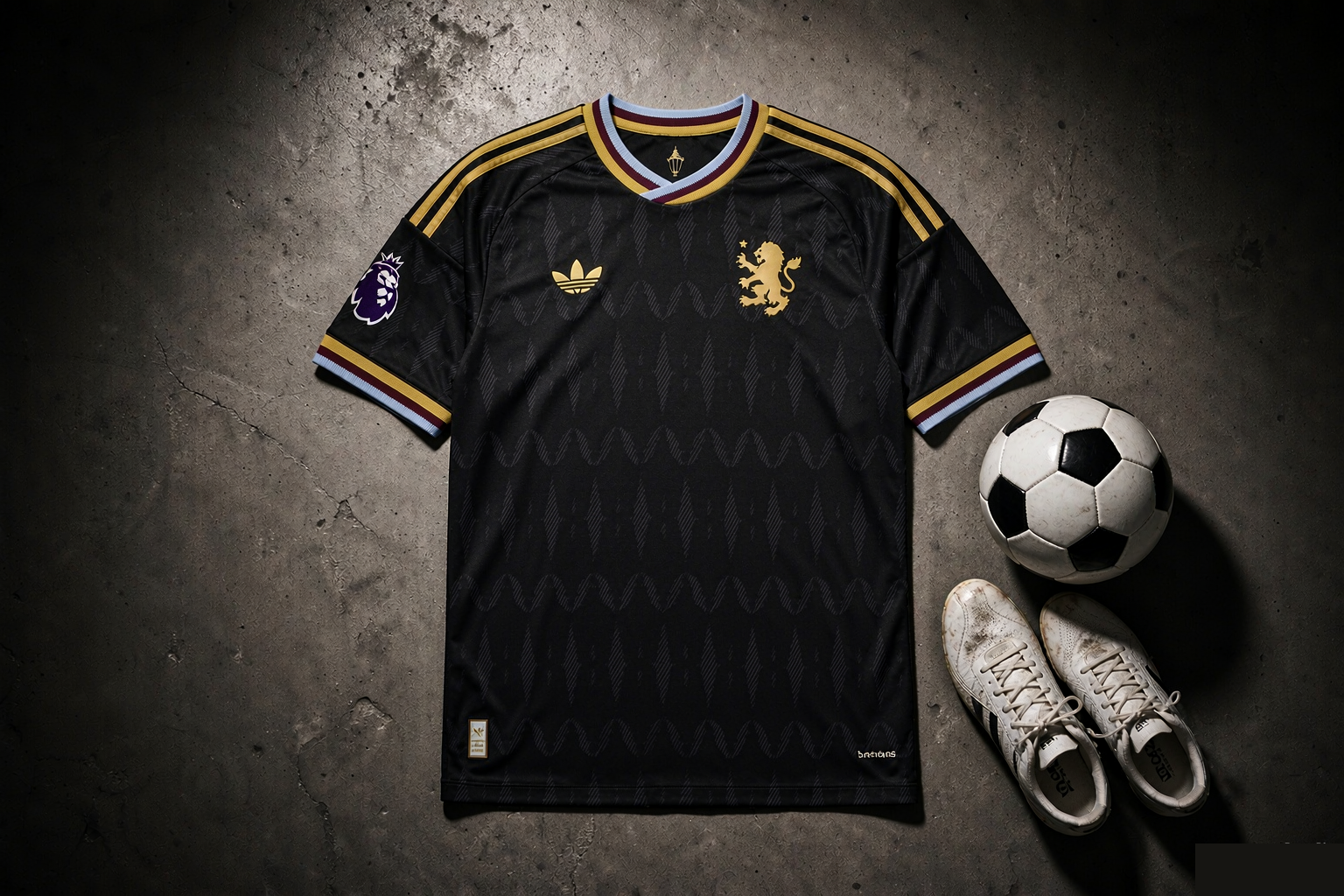Aston Villa 2026/27 away on-field jersey in black laid flat with soccer ball and boots, editorial product photograph