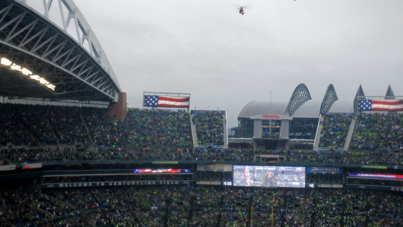 Lumen Field packed with the 12s for a Seattle Seahawks home game, with a pre-game flyover overhead