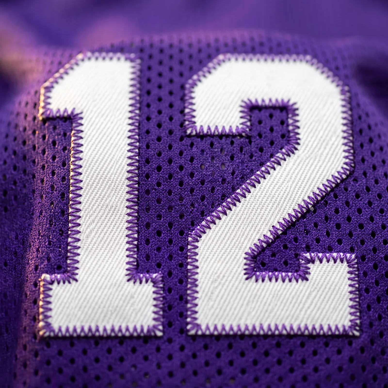 Close-up of stitched twill numbers on a navy blue NFL jersey