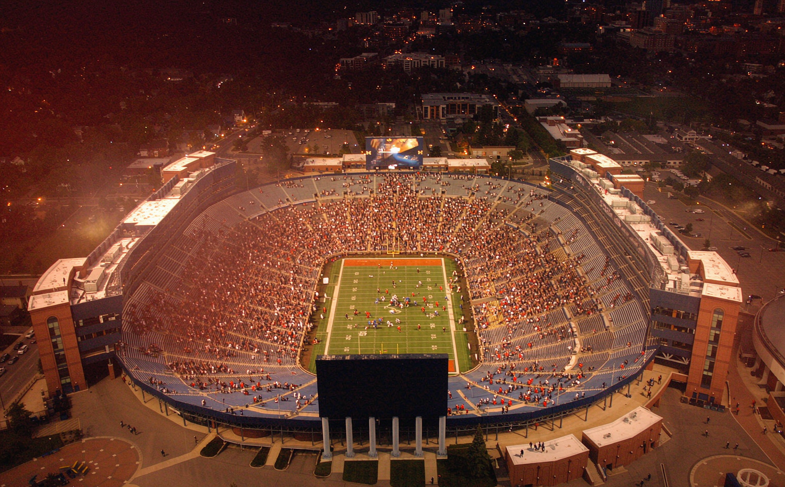A packed college football stadium under Saturday night lights