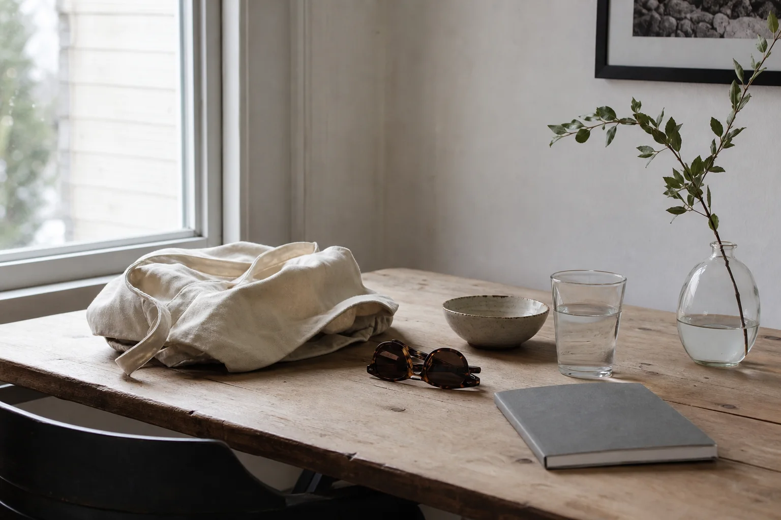 Everyday objects on a naturally lit wooden table