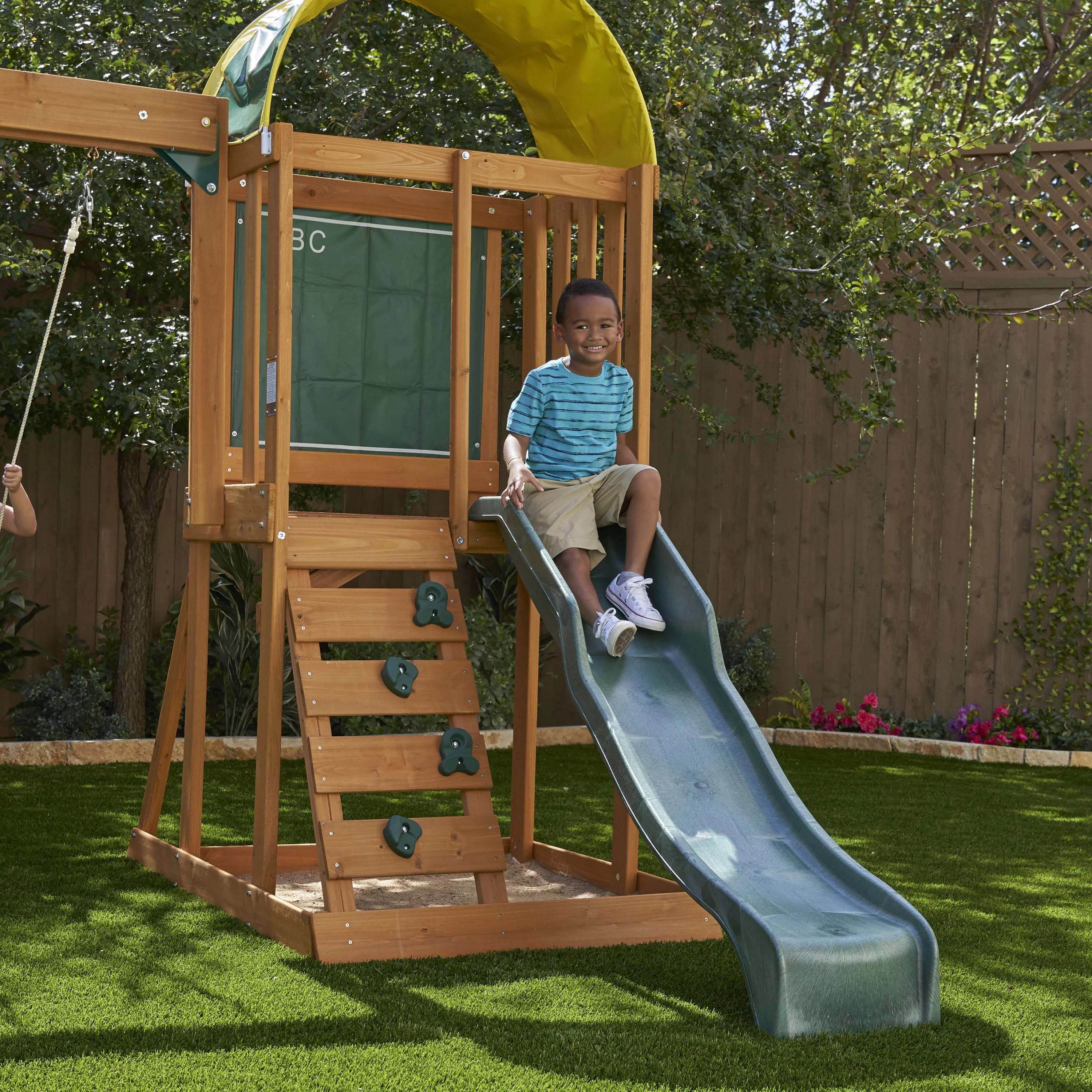 KidKraft Ainsley Wooden Outdoor Swing Set with Slide and Rock Wall - Radiant Selections