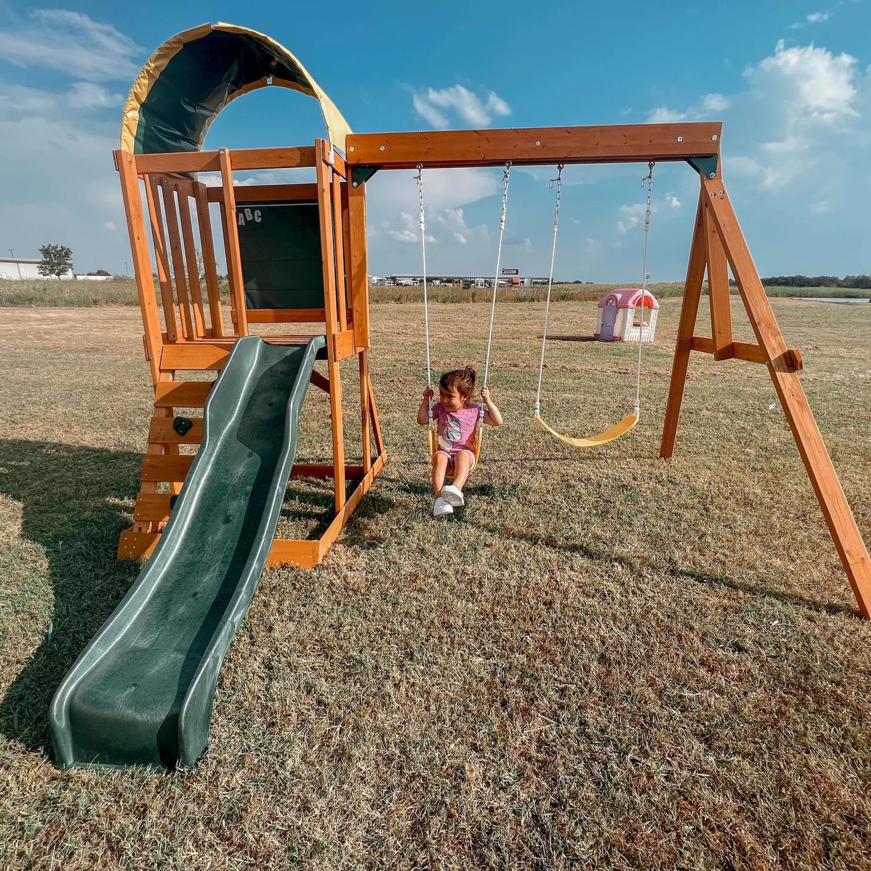 KidKraft Ainsley Wooden Outdoor Swing Set with Slide and Rock Wall - Radiant Selections