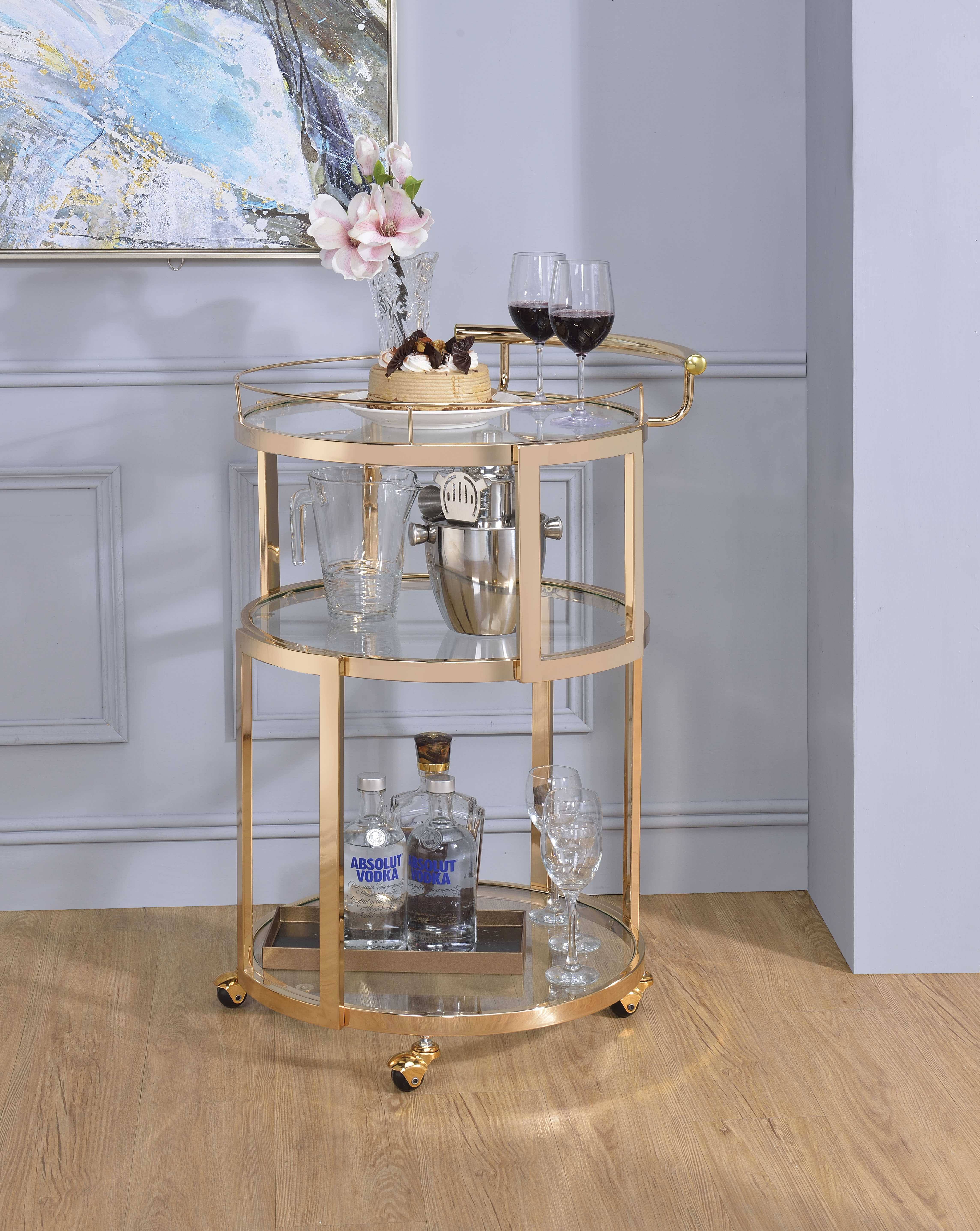 Benzara BM194341 Three Tiered Metal Serving Cart with Glass Inserted Shelves and Curved Side Handle Gold