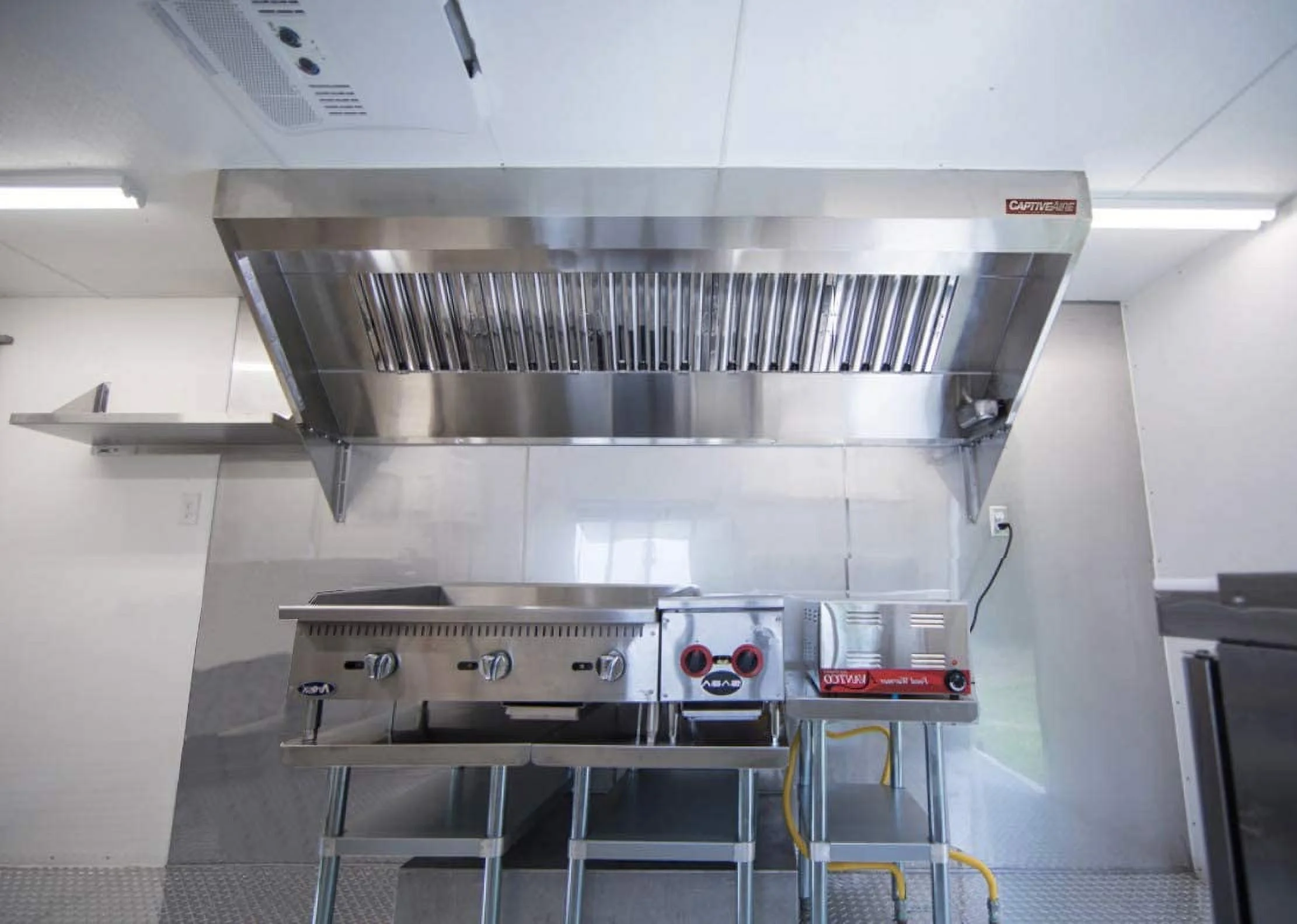 CAPTIVE-AIRE Food Truck Low Profile Exhaust Hood System Includes a stainless steel exhaust hood, an exhaust fan, an adjustable duct section