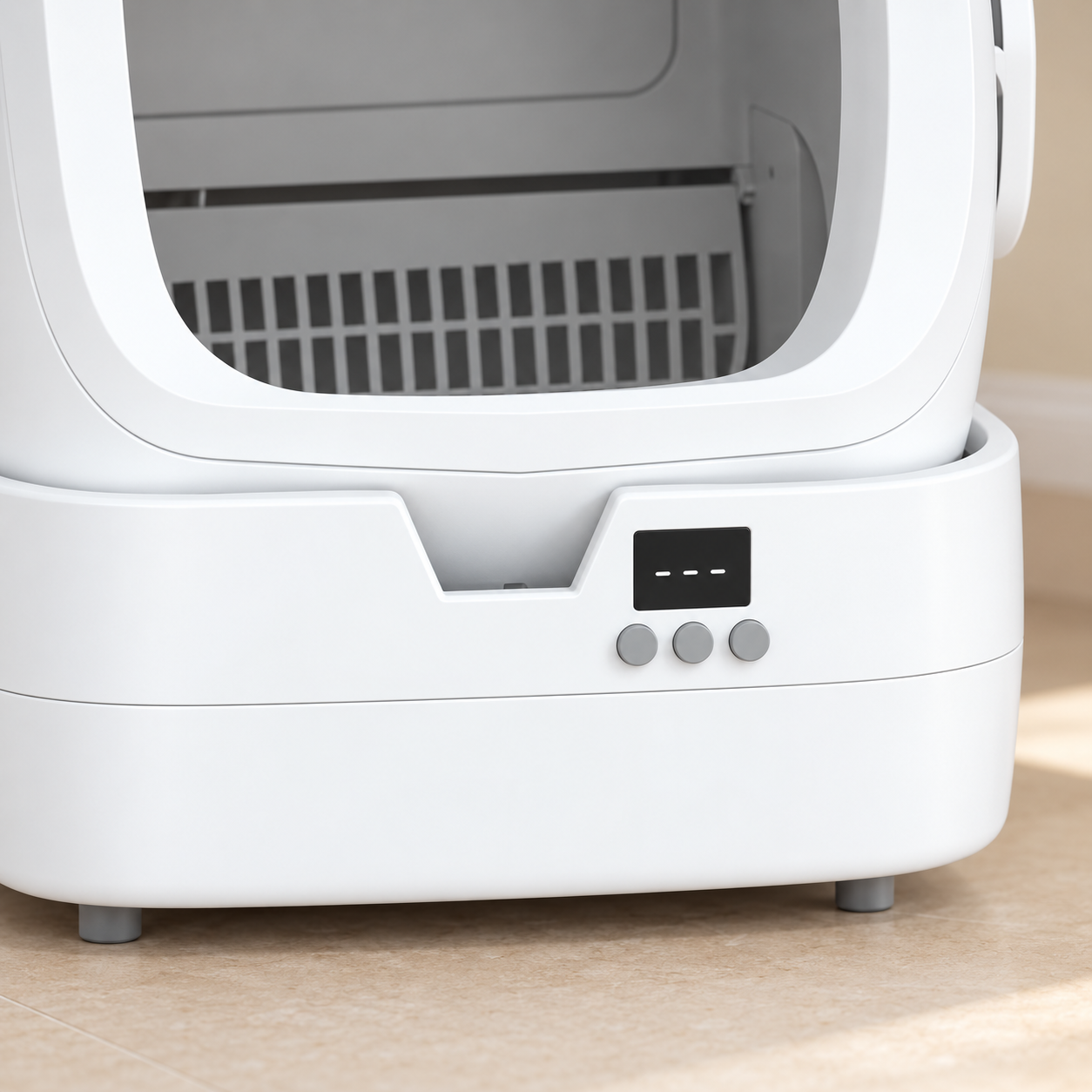 Close-up of the front display and three controls on the white litter box base