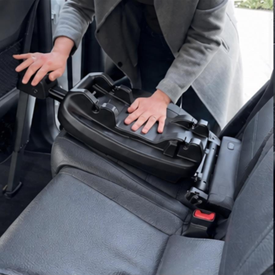 Hands pressing evenly on both sides of the vehicle docking base to confirm its locks