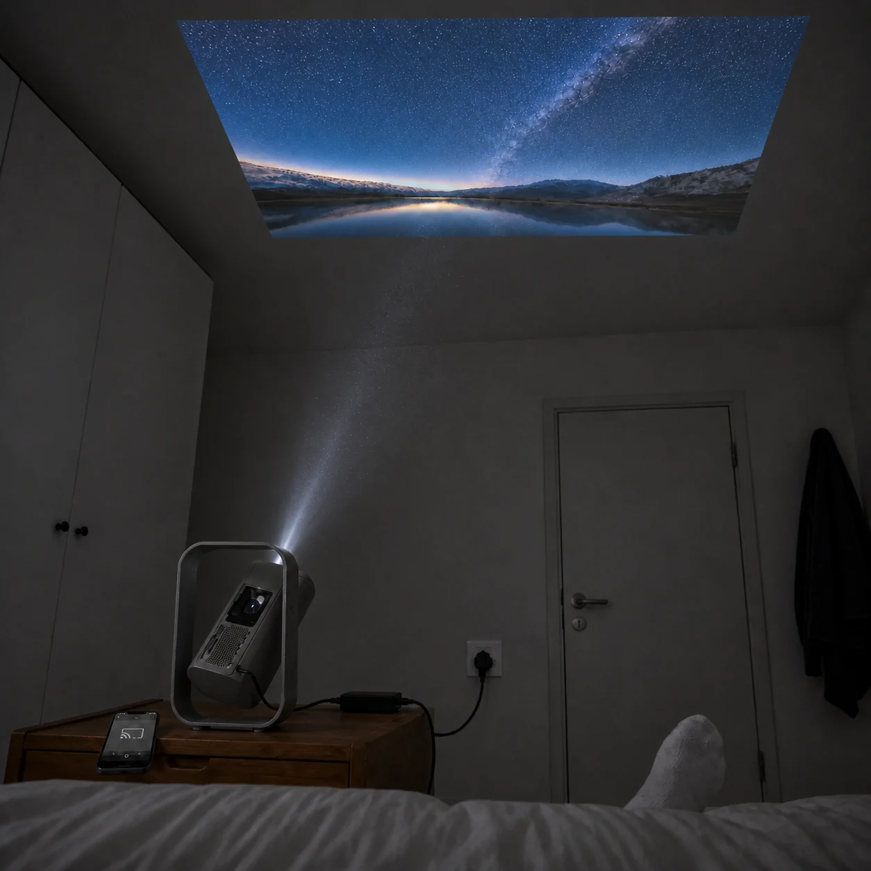 Powered bedside projector tilted toward a sharp ceiling picture with the light path and wireless-cast phone visible