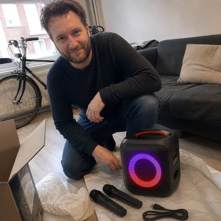 Customer unpacking the speaker, two microphones and power cord