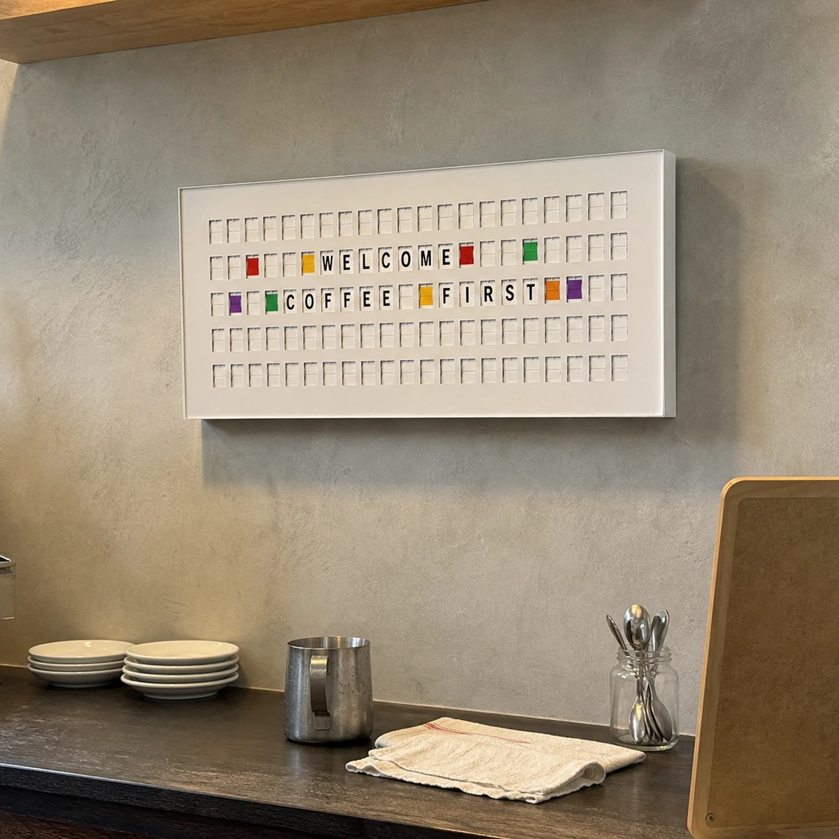 Customer photo of a white 132 Bits display above a small cafe counter