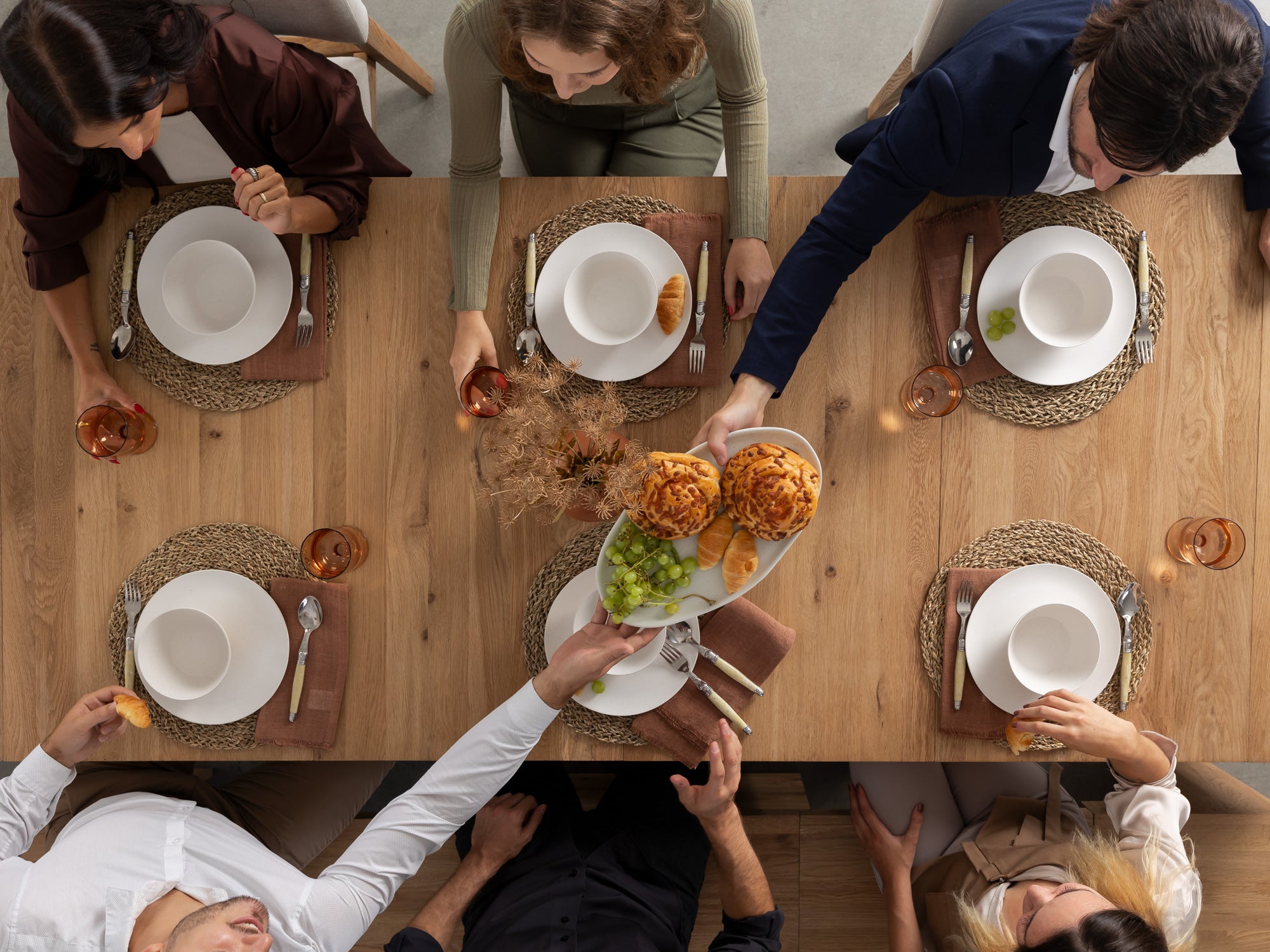 Large group sharing a meal around the fully extended dining table