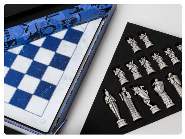 Chessboard and sculptural pieces arranged in a protective tray