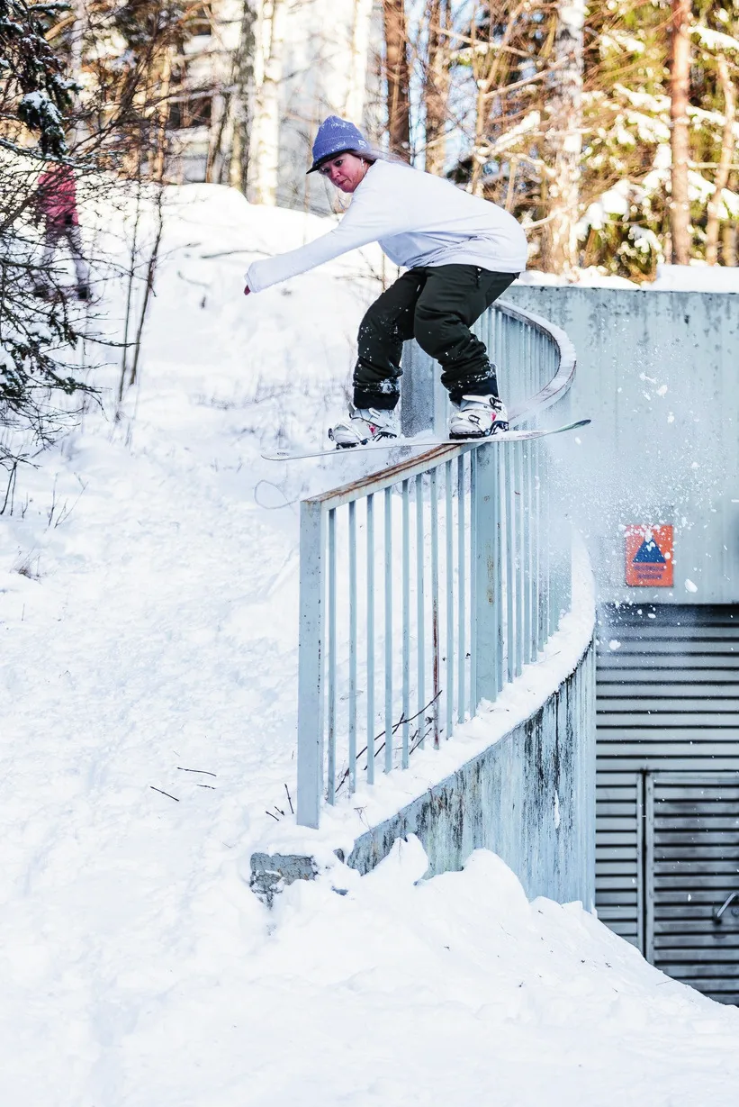Rider sliding a snow-covered rail