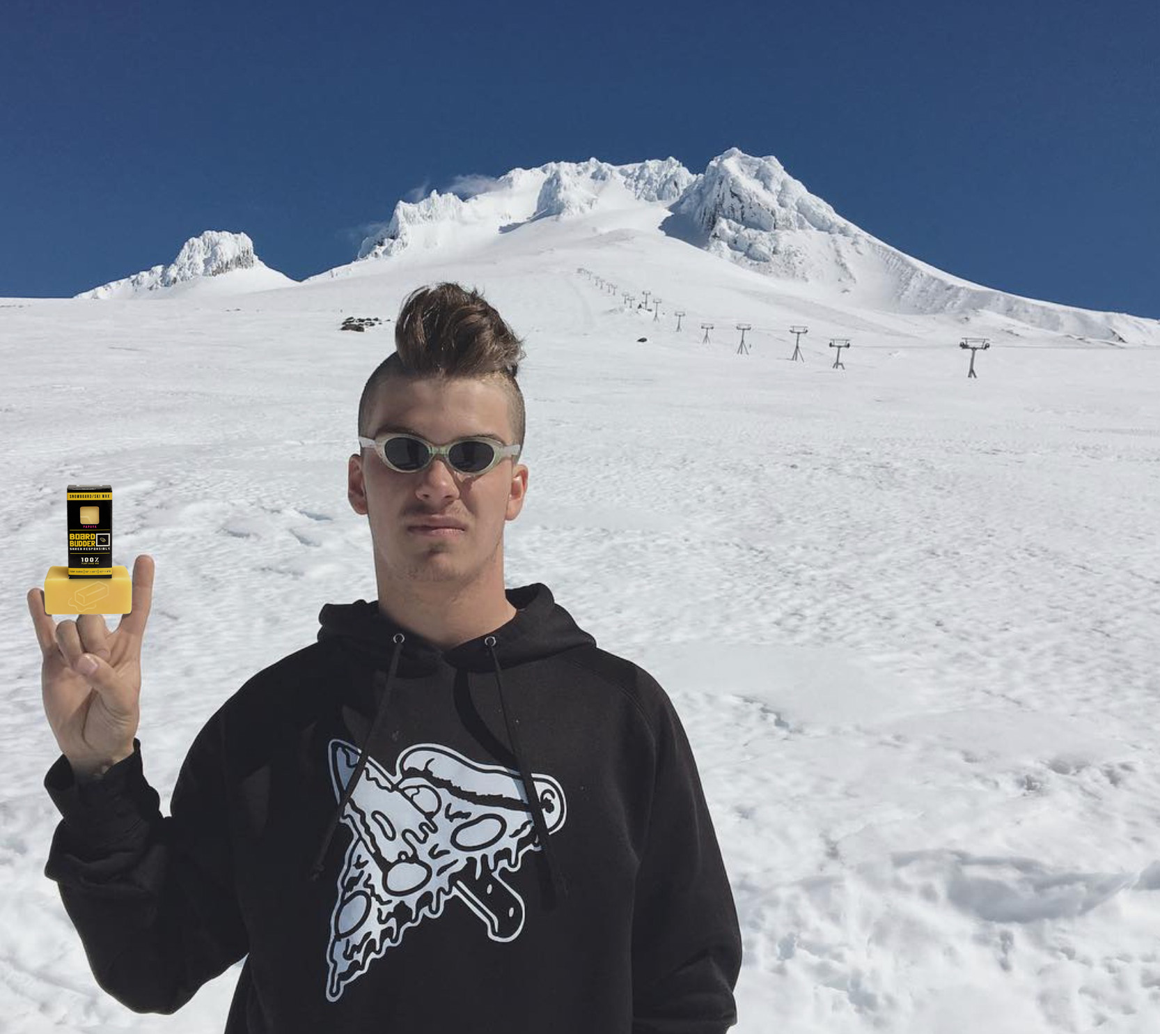 Budder Crew rider holding a bar of Board Budder wax on the mountain