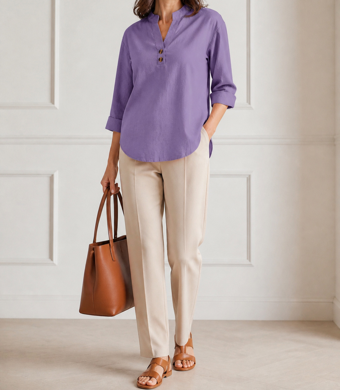 Elara blouse styled with cream trousers and leather accessories