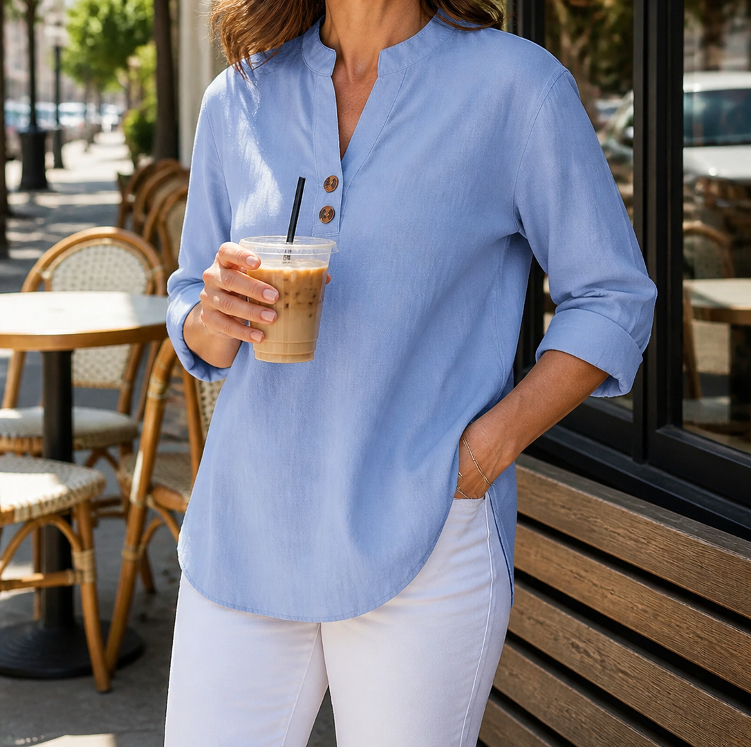 Light blue Elara blouse at an outdoor cafe
