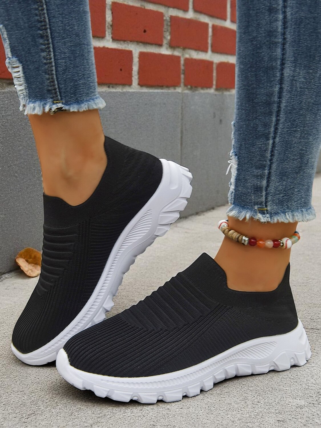 Women's Lightweight Knit Slip-On Walking Sneakers — Black pair on foot