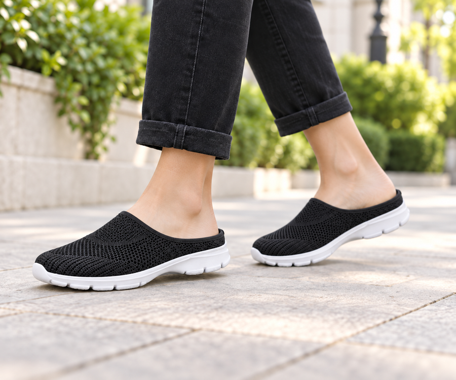 Black knit slip-on walking mules worn outdoors